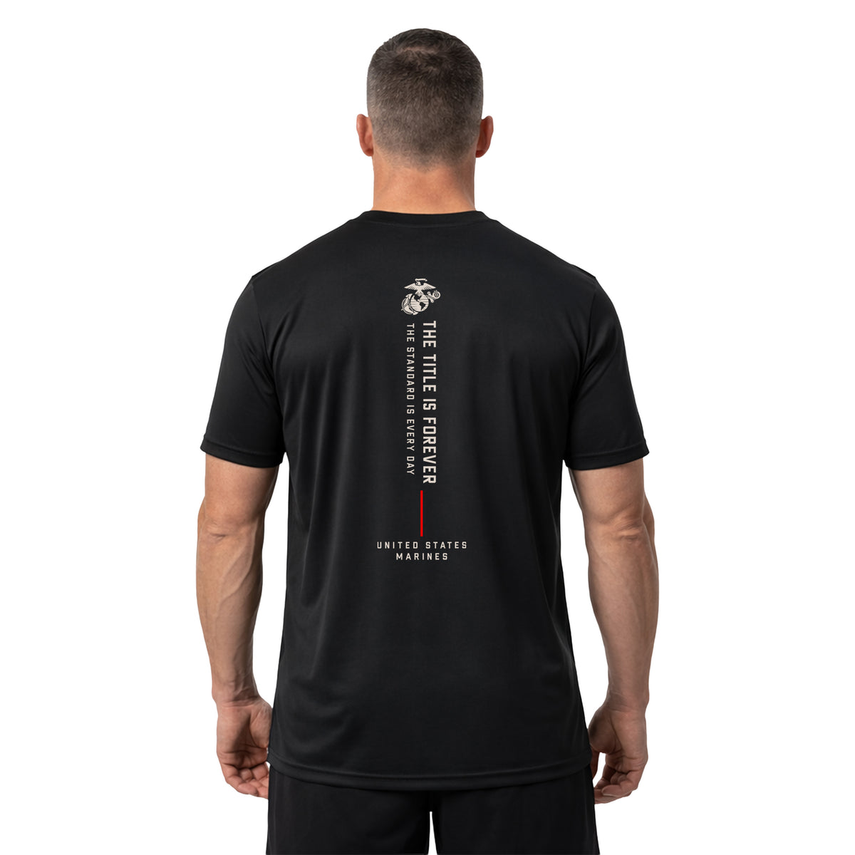 man wearing Black The Title Is Earned Never Given Performance T-Shirt with vertical “The Title Is Forever. The Standard Is Every Day.” back design