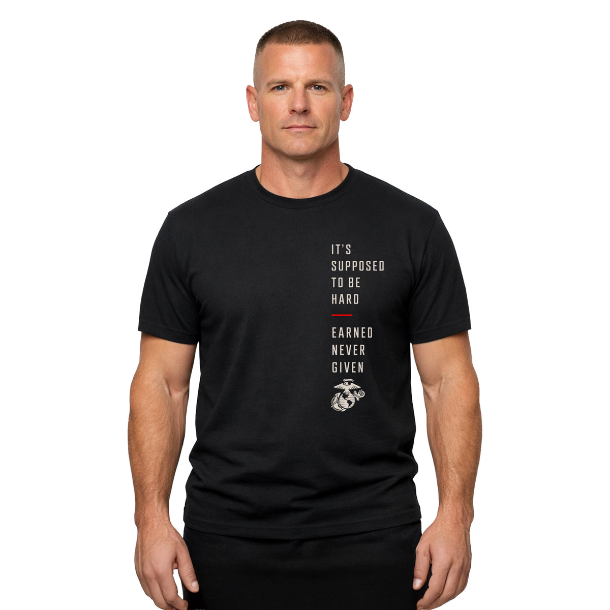 Man wearing Black USMC T-shirt featuring “It’s Supposed to Be Hard – Earned Never Given” vertical chest graphic with Eagle, Globe and Anchor and red accent line