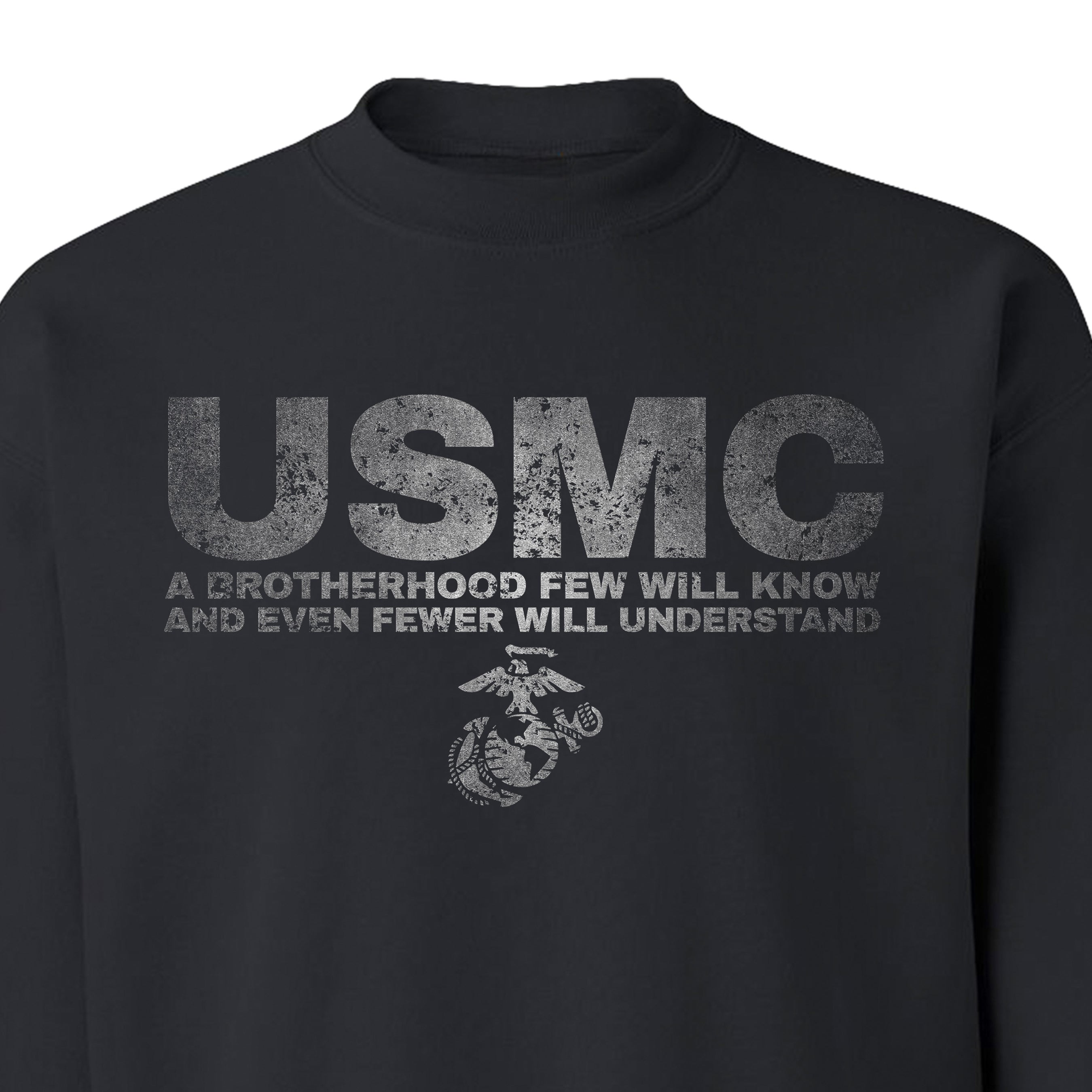 Black Marine Corps sweatshirt with distressed silver-gray text reading “USMC – A Brotherhood Few Will Know and Even Fewer Will Understand,” featuring the Eagle, Globe, and Anchor emblem beneath the text.