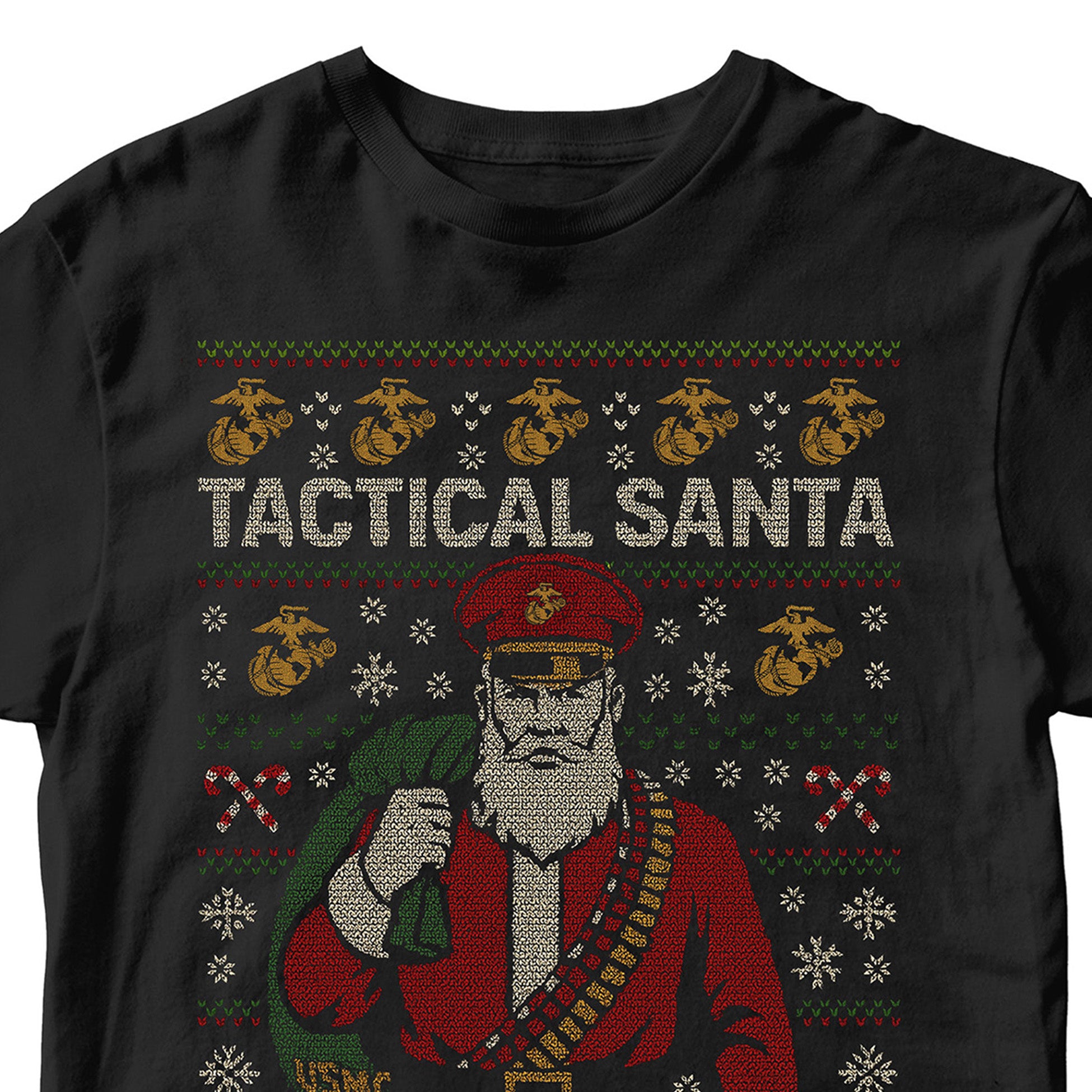 Black USMC Christmas T-shirt featuring stitched-style Tactical Santa in red uniform with ammo belt, USMC seabag, snowflakes, candy cane patterns, and bold text ‘Tactical Santa Drop.’ Marines Christmas Tee